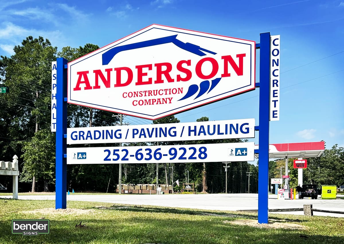 Anderson Construction Company multi-panel post sign against a blue sky