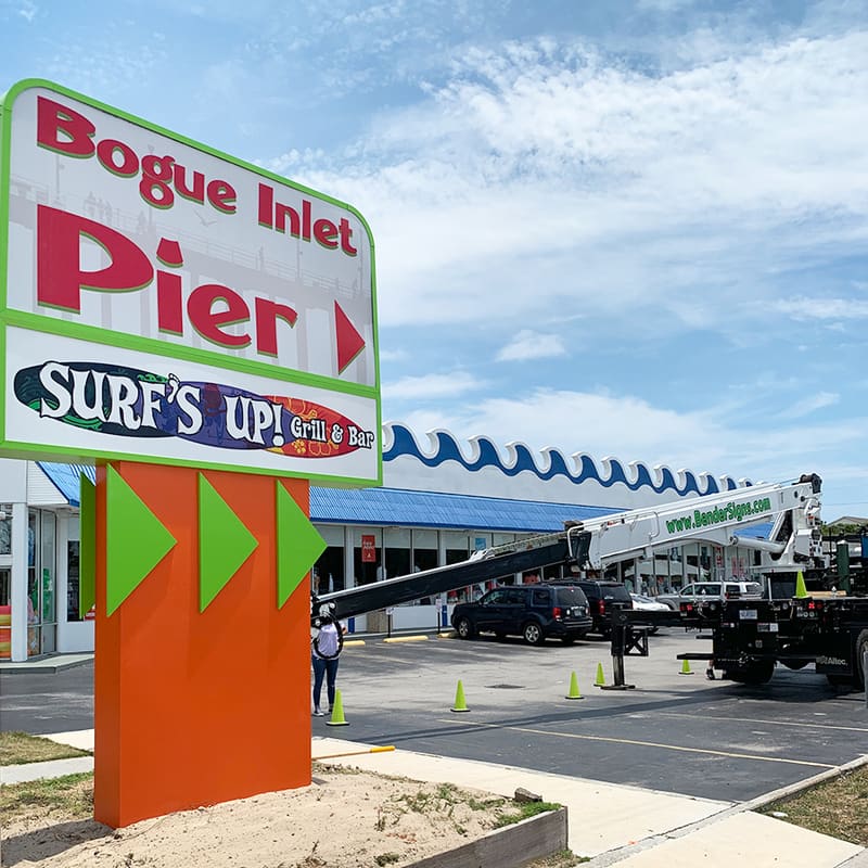 Colorful Bogue Inlet Pier and Surf’s Up Grill pylon with Bender crane truck working