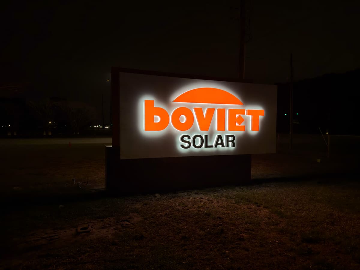 Boviet Solar halo-lit monument sign glowing white at night