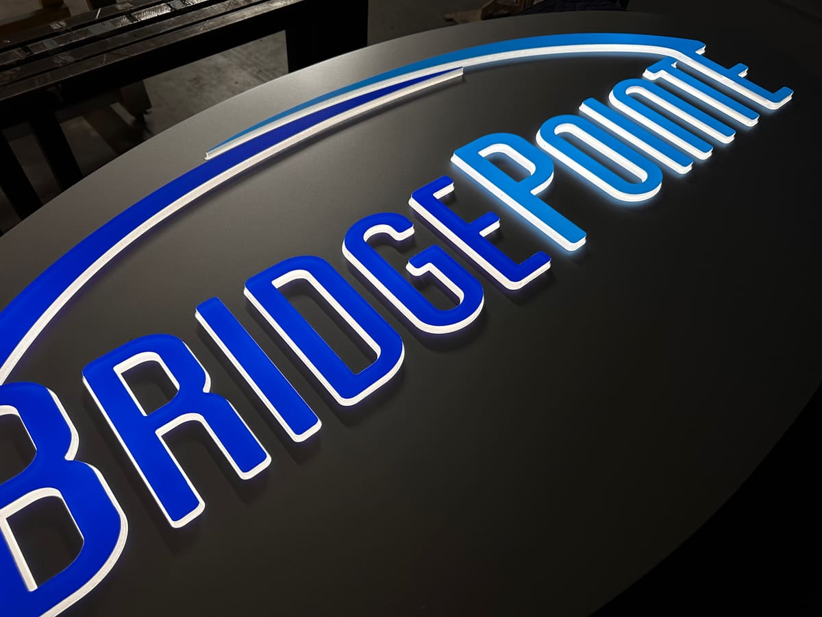 BridgePointe halo-lit oval sign face illuminated during fabrication