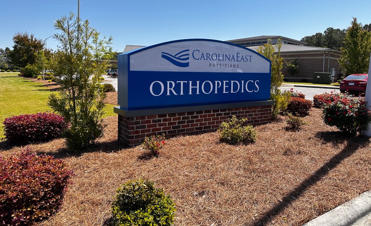 CarolinaEast Physicians Orthopedics monument sign on a brick base