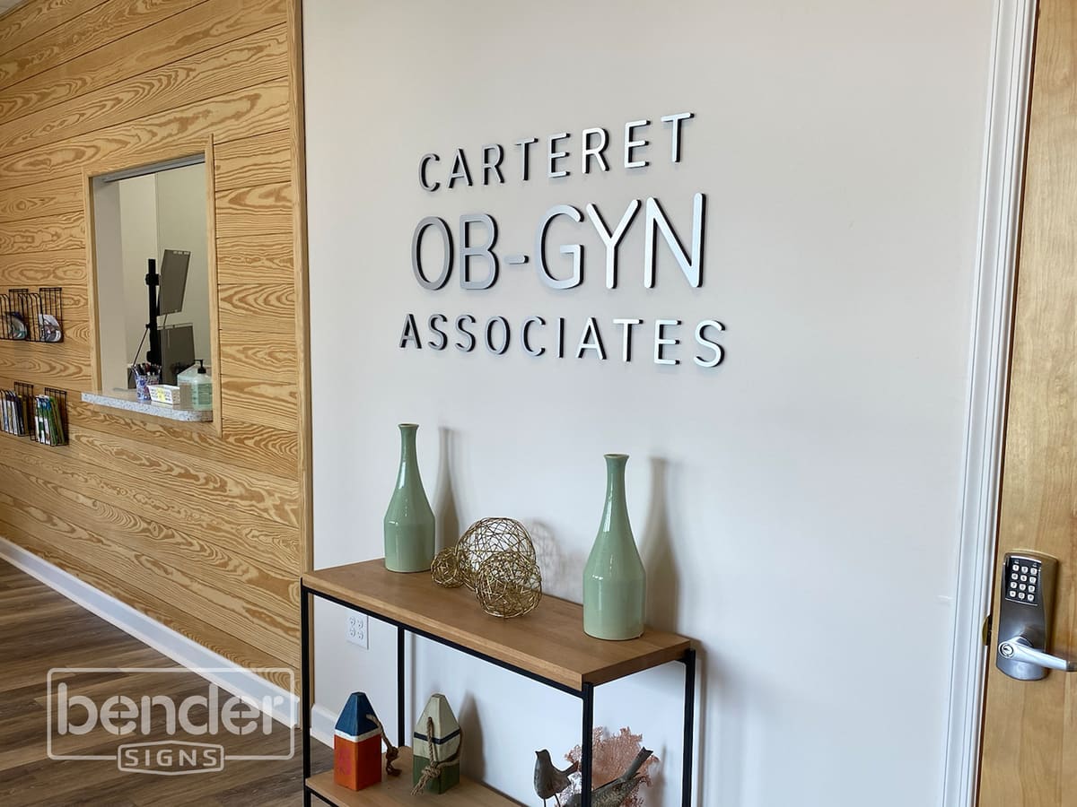 Carteret OB-GYN Associates dimensional lobby letters above a console table