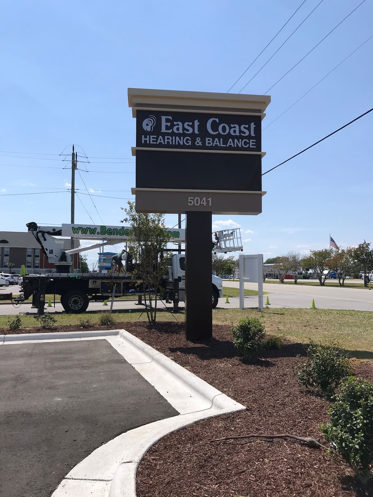 East Coast Hearing & Balance pylon with the Bender crane truck working in the background