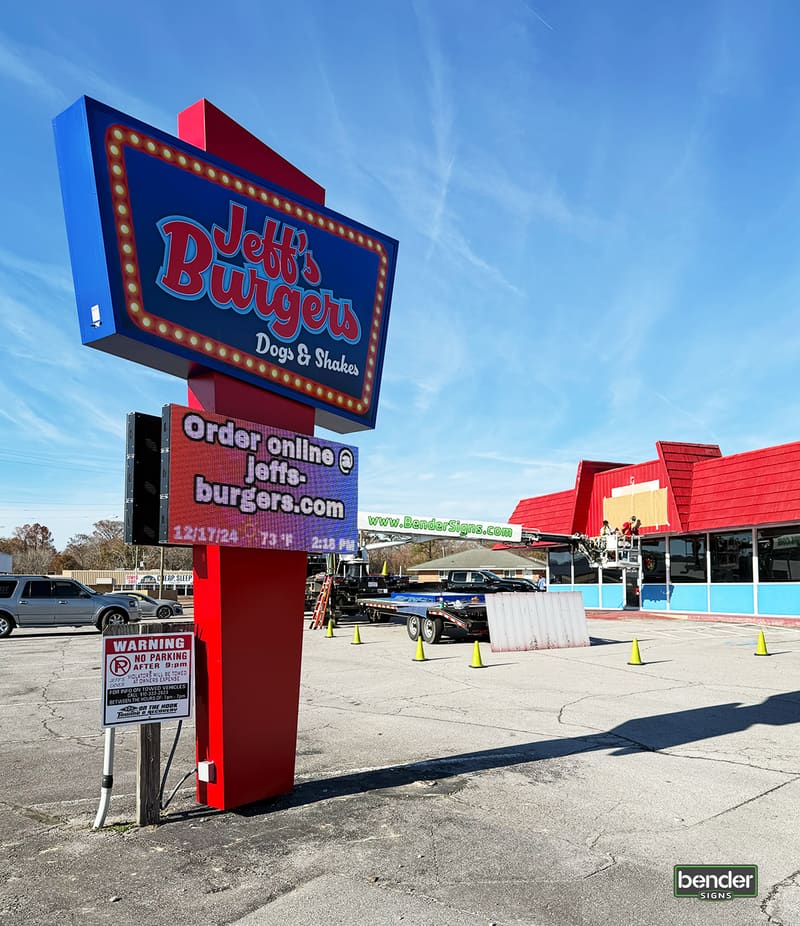 New Jeff’s Burgers retro pylon sign with LED message center in front of the red-roof diner