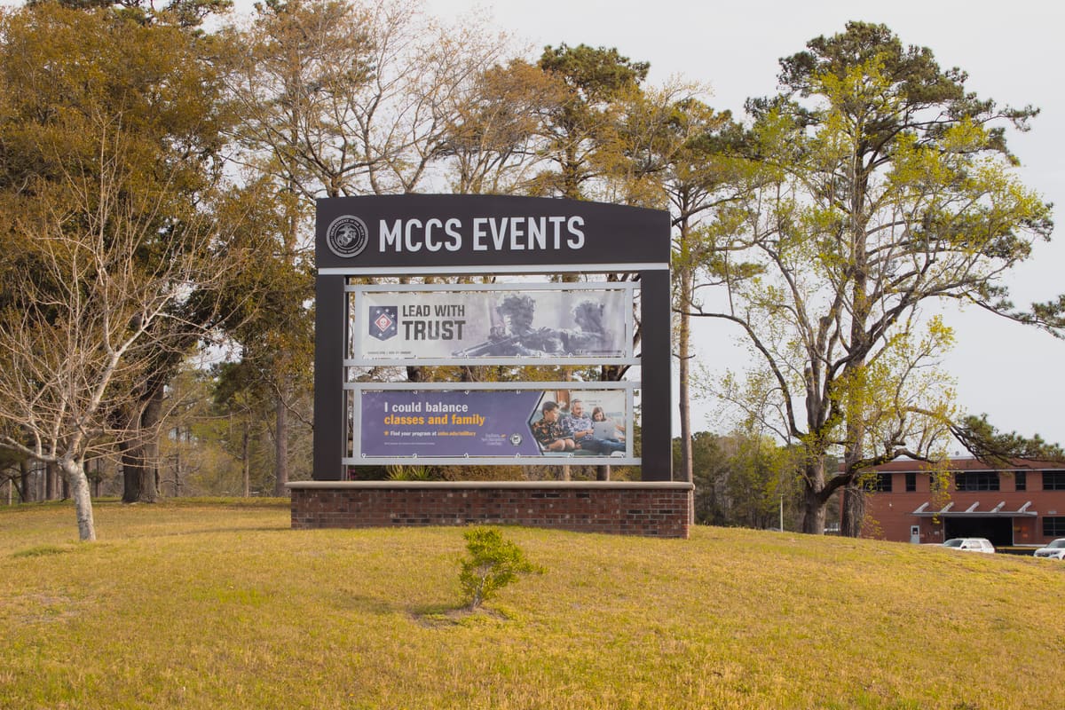 MCCS Events monument sign with interchangeable banner frames in golden-hour light