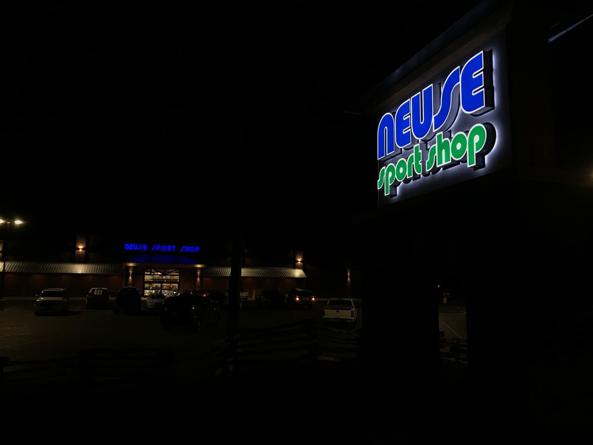 Neuse Sport Shop illuminated channel letters glowing at night