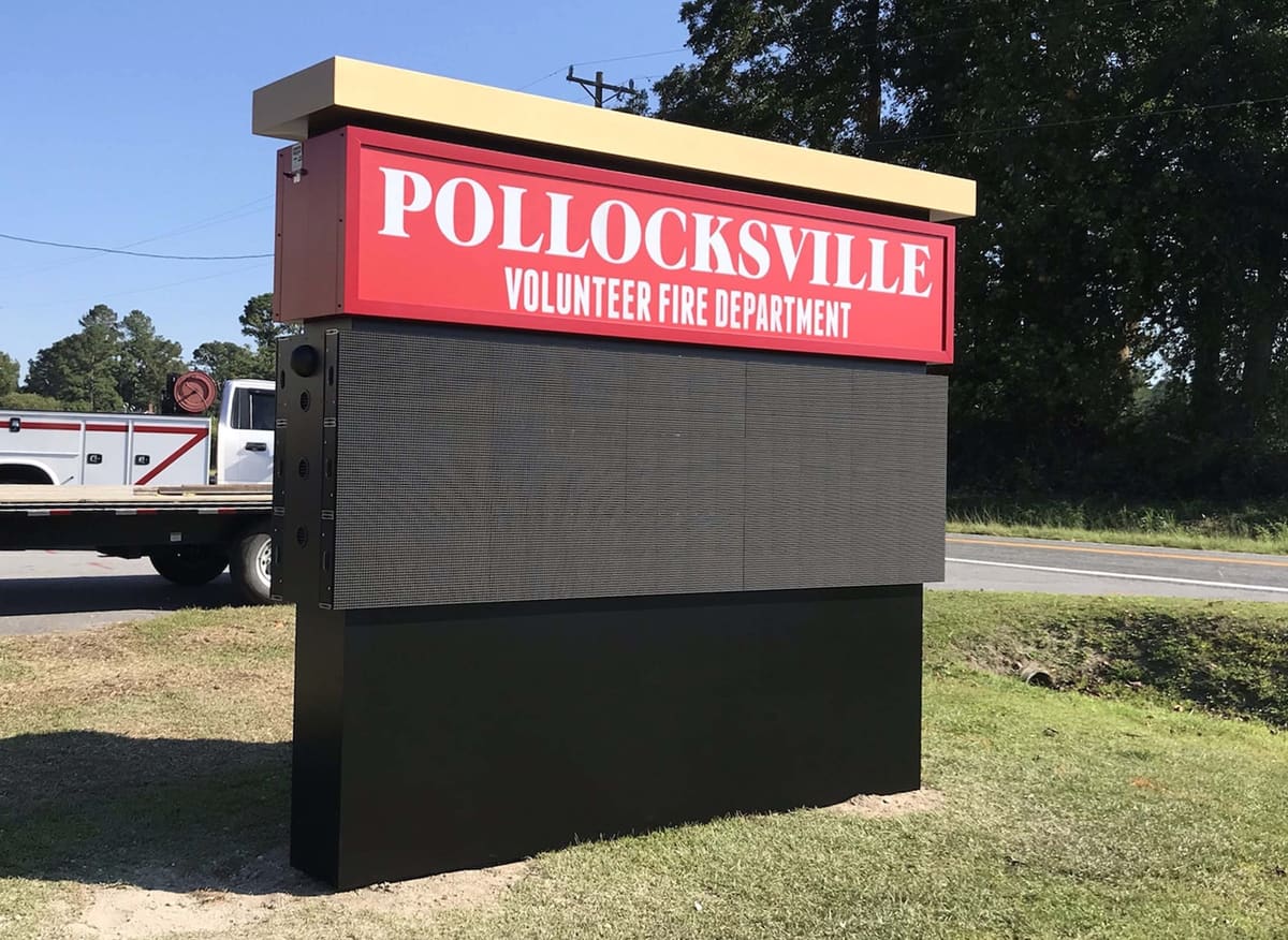Pollocksville Volunteer Fire Department monument sign with LED board, fire truck behind