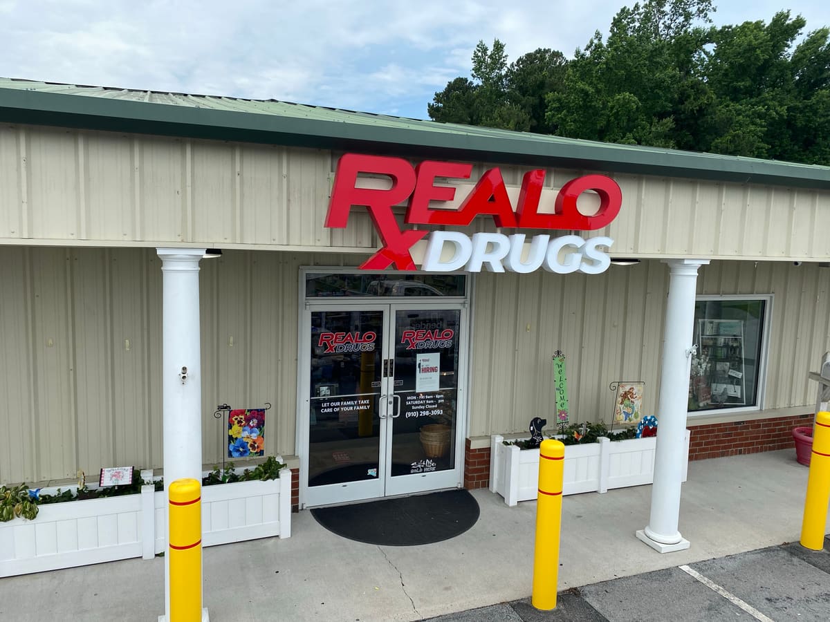 Realo Drugs channel letters on a tan building with columned entrance