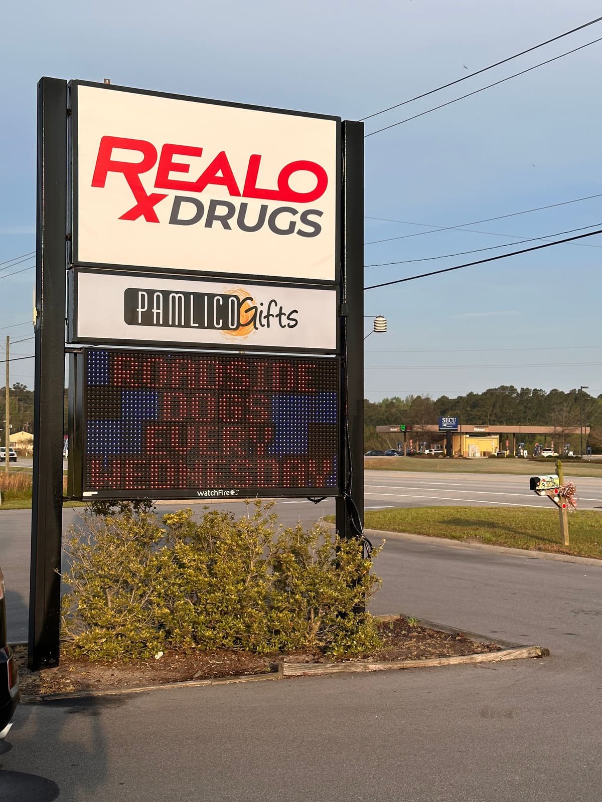 Realo Drugs and Pamlico Gifts pylon with Watchfire LED board at golden hour