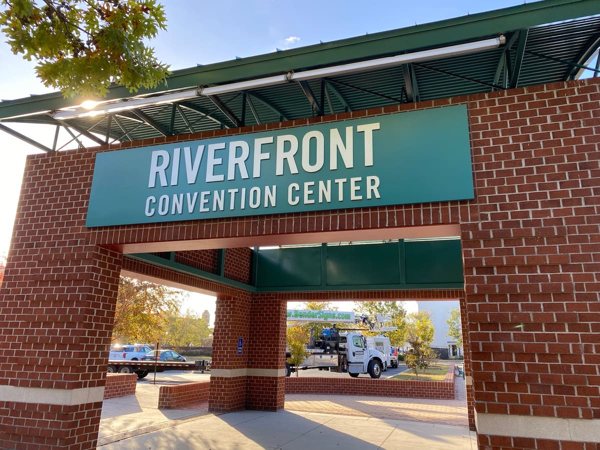Riverfront Convention Center panel sign on the brick archway in golden-hour light