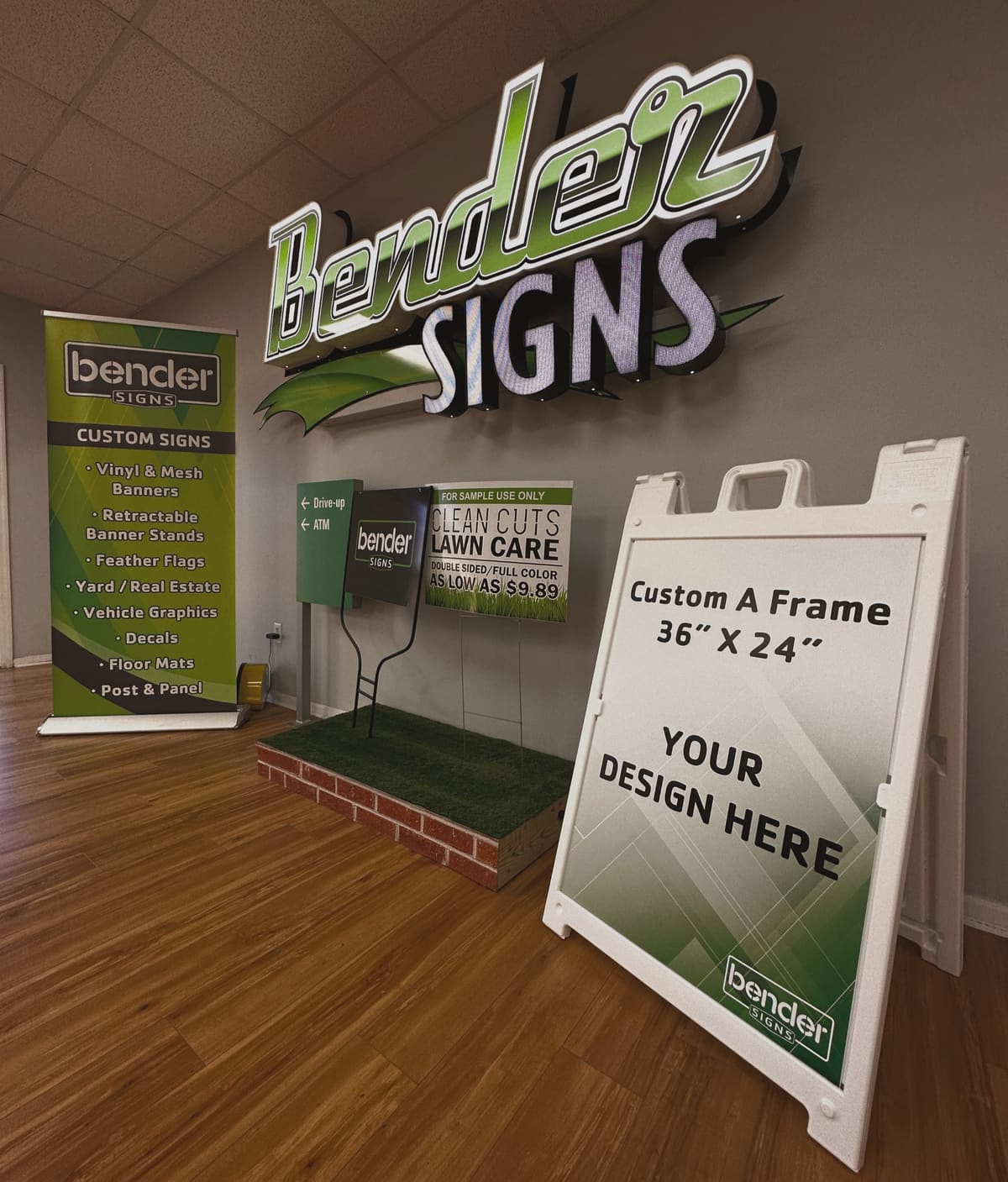 Bender Signs showroom with illuminated dimensional logo, banner stand and A-frame samples