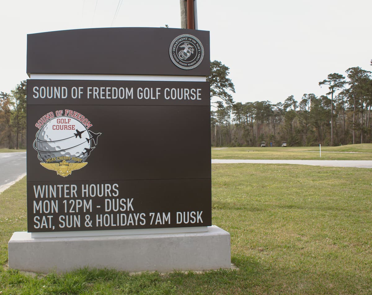 Sound of Freedom Golf Course monument sign with changeable hours panel at Cherry Point
